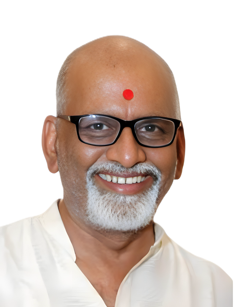 Sanjay Shrivastava, smiling, in a white kurta with a red tilak
